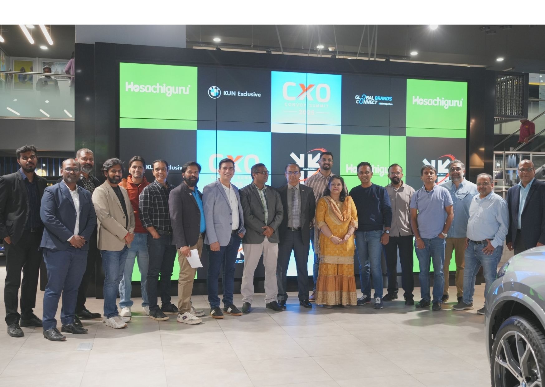 CXO Inner Circle — group photo at CXO Summit with branded display