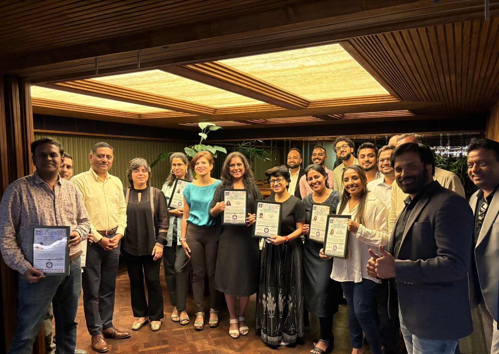 CXO Inner Circle — members with certificates at warm-lit venue
